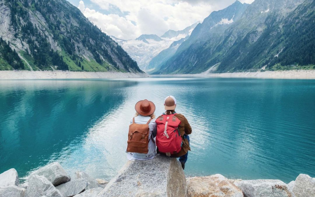 two people sitting on rocks looking at Austrian view